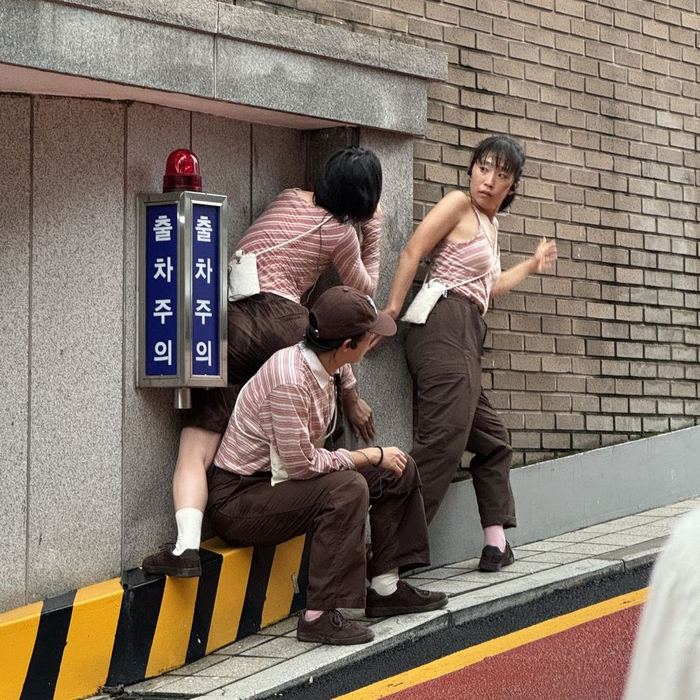 Four performers gathered beside a parking entrance during The Fantasy-Architects’ Guide to the Gaps of the City