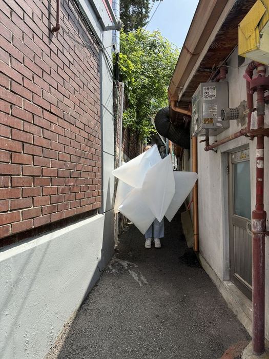 A white lightweight volume occupying a narrow passage