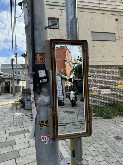 A mirror attached to a utility pole