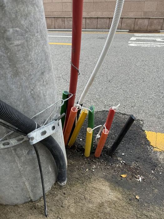 Colourful pipes beside a utility pole